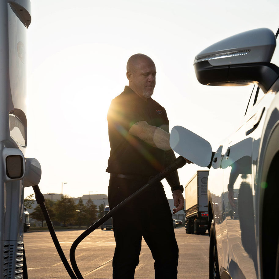 man using ev-charging station to charge hybrid car
