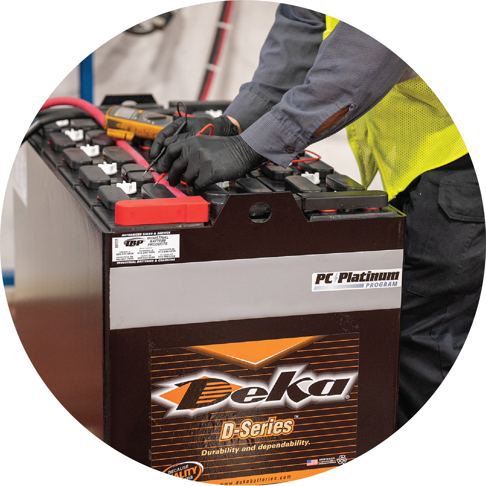 A Deka D-series battery provided by IBP's power management program, being used by a man with gloves on